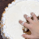 hand digging into frosted cake